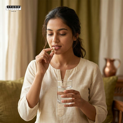 Woman taking Time Capsule anti-ageing supplement with a glass of water