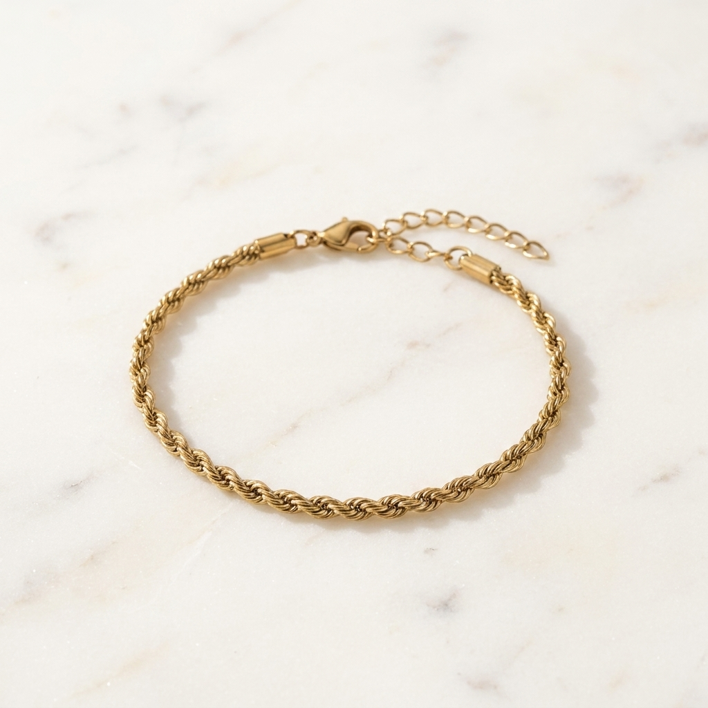 Gold-toned Signature Rope Chain Bracelet laid in a soft curve on a bright premium surface