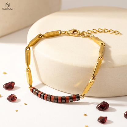 Passion Golden Rice Bracelet with red Garnet accents on a bright cream and gold set