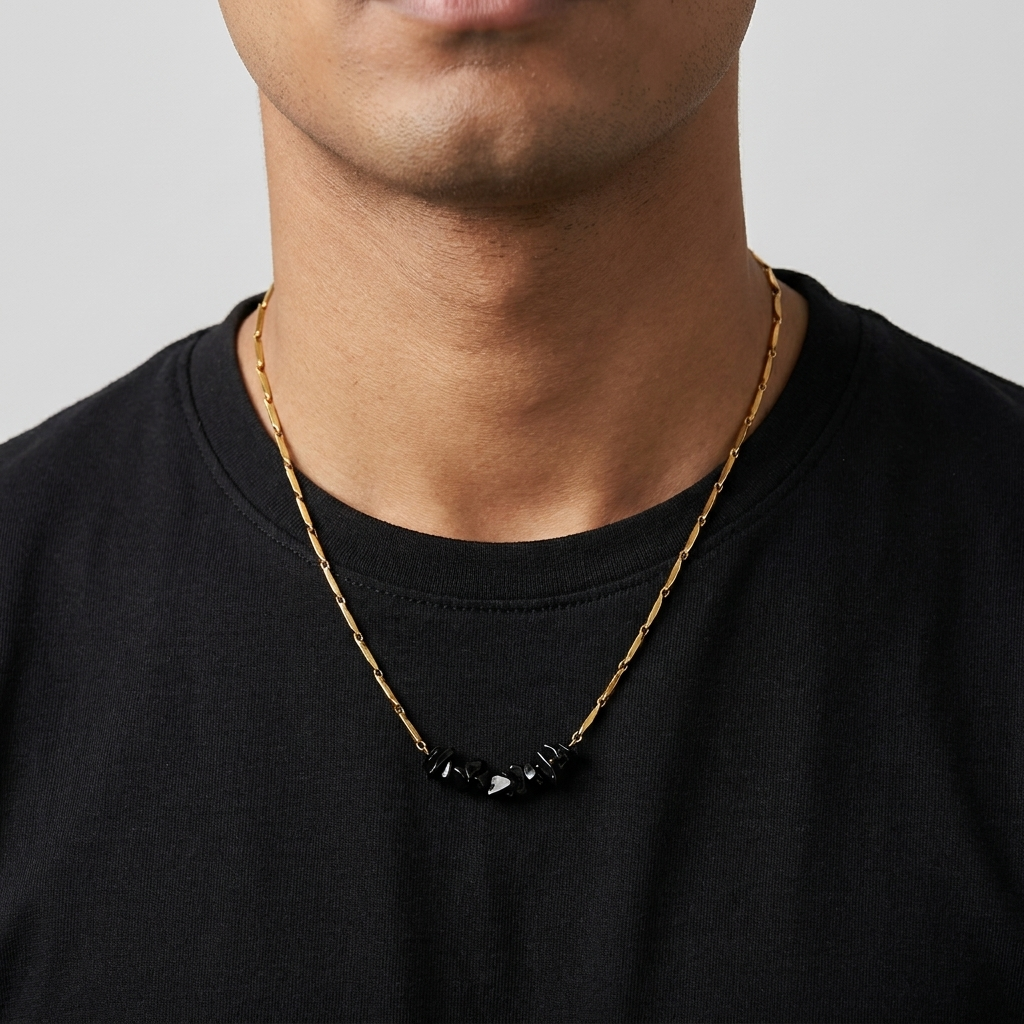 Man wearing the gold-tone Obsidian rice chain necklace with a plain black tee