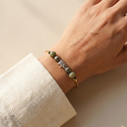 Bracelet worn on a woman's wrist styled with a neutral outfit