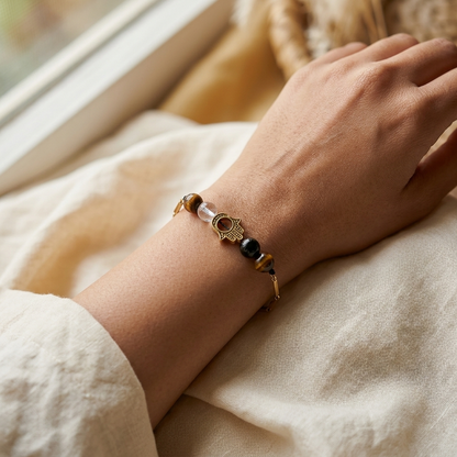 Woman wearing the Nazar Sutra gold-toned Hamsa crystal bracelet on her wrist