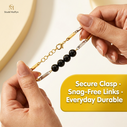 Black Obsidian bracelet held taut between fingers in a secure-clasp durability test
