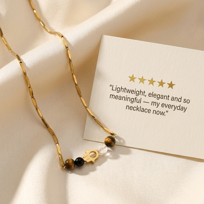 Five-star customer review card beside the golden Hamsa crystal rice chain necklace